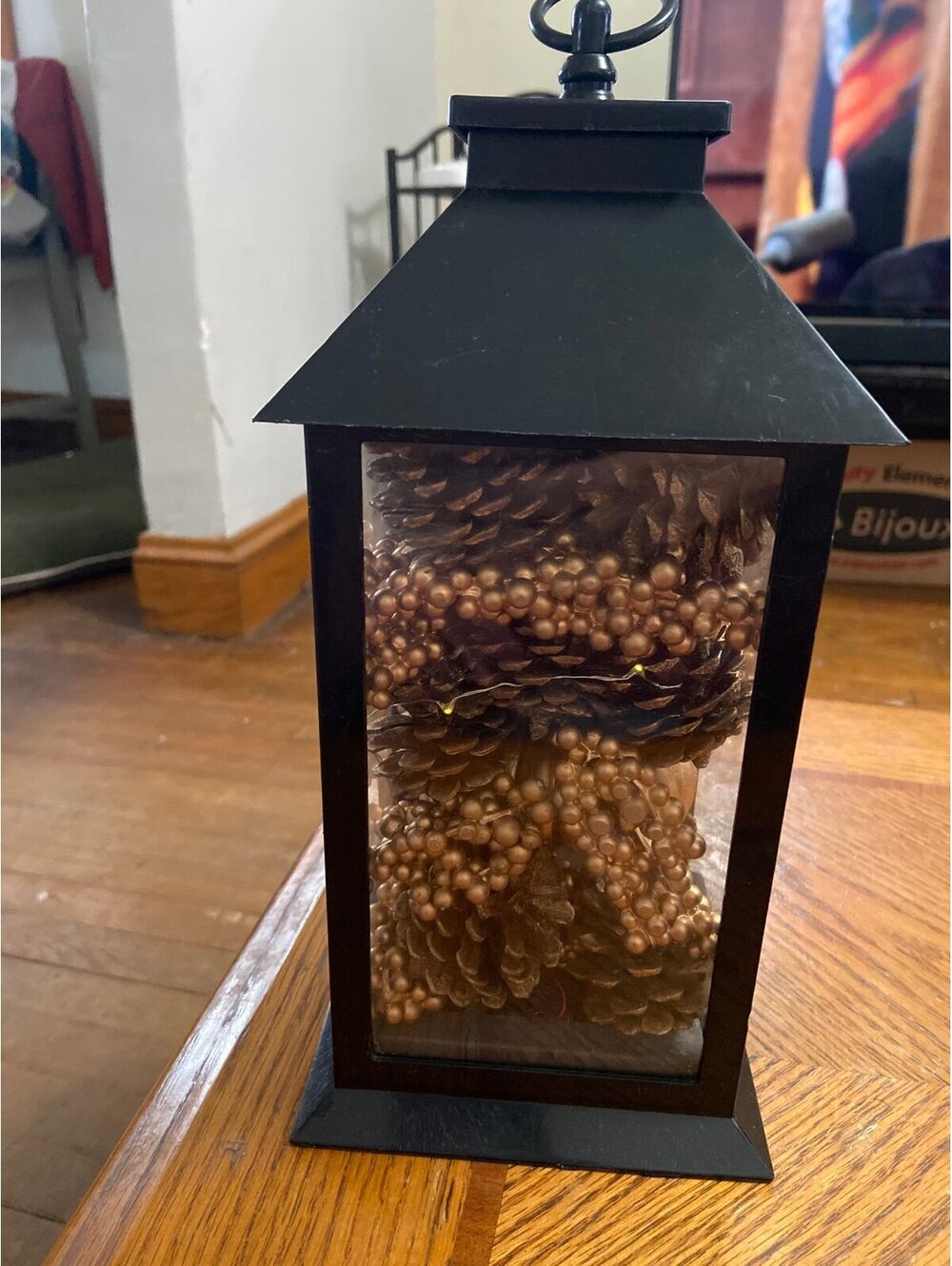 Lantern with pine cones and decorations